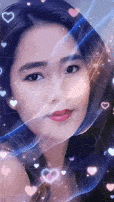 a close up of a woman 's face surrounded by hearts and sparkles .