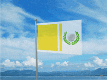 a yellow and white flag with a laurel wreath on it is flying in the wind