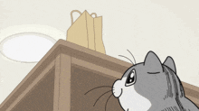 a cartoon cat is looking up at a brown bag on top of a table