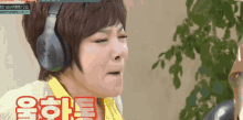 a woman wearing headphones is making a funny face in a video