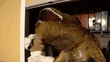 a person in a t-rex costume is putting something in a plastic bag