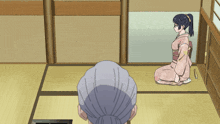 a woman in a kimono is kneeling down in front of an older woman