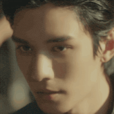 a close up of a man 's face with a shadow on his forehead