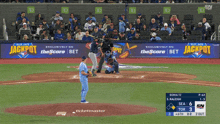a blue jays baseball game is being played in front of a banner for jackpot