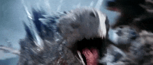 a close up of a monster with its mouth open and its tongue hanging out .