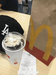 a cup of mcdonald 's ice cream next to a mcdonald 's bag with 199 on it