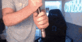 a man is holding a cane in his hands in front of a chair .