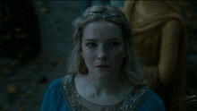 a woman in a blue and gold dress with the name martin on the bottom right