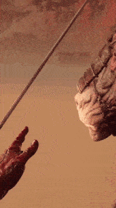 a person holding a rope in front of a giant monster