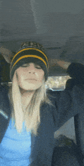 a woman wearing a green bay packers beanie and a columbia jacket