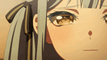 a close up of a girl 's face with a tear coming out of her eye