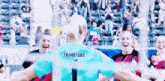 a female soccer player wearing a jersey that says frankfurt on the back