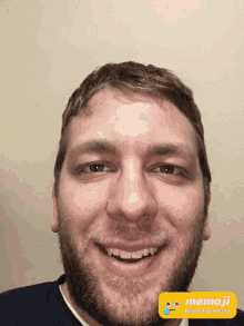 a man with a beard is smiling with a memoji from facetune app on his face