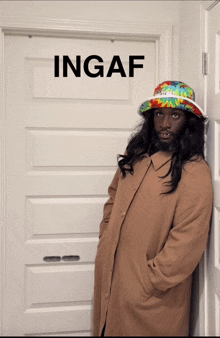 a man leaning against a door with ingaf written on the door