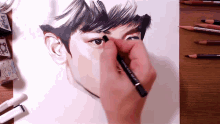 a person is drawing a man 's face with a pencil that says ' kingfisher ' on the bottom