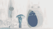 a couple holding an umbrella standing next to a giant totoro