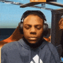 a man wearing headphones is making a funny face while playing a video game .