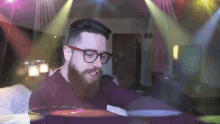 a man with glasses and a beard playing a record