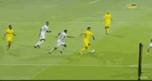 a group of soccer players on a field with a referee in the background and the word life on his shirt
