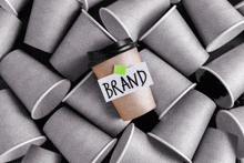 a cup of coffee with a sticky note that says brand