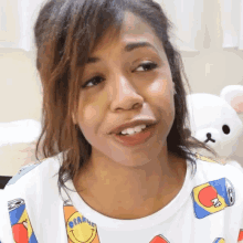 a woman wearing a t-shirt with a smiley face on it