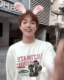 a young man wearing bunny ears and a t-shirt that says " atamitiv " on it