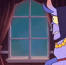 a cartoon character with horns is sitting in front of a window .