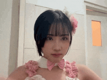 a girl with short hair and a pink bow tie