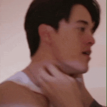 a close up of a man 's neck with a woman holding it .