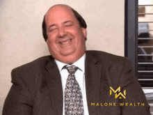 a man in a suit and tie is smiling with the words malone wealth in the corner