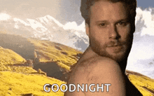 a man without a shirt says goodnight in front of mountains