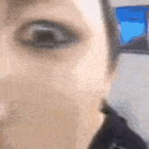 a close up of a person 's eyes with a blue background