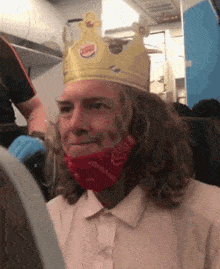 a man wearing a burger king crown on his head