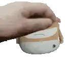 a person 's hand is holding a stuffed animal on a white background .