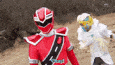 a red power ranger says okay while standing next to a white ranger