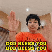 a person wearing a red shirt that says turn up and says god bless you