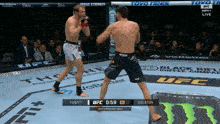 two men are fighting in a ufc ring with a toyo tires banner behind them