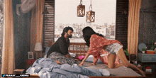 a man and a woman are laying on a bed with a watermark that says pranay_varma