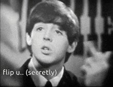 a black and white photo of a young man with the words flip u.. secretly