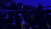 a crowd of people with their arms in the air