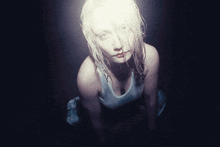 a woman with wet hair and a plunging tank top