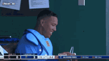 salvador perez is sitting in the dugout during a baseball game against the royals