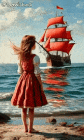 a girl in a red dress stands on the beach looking at a sailboat