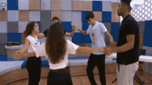 a group of people are dancing in a room with a piano