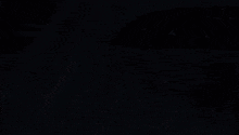 a plane is flying over a body of water with snow falling from the sky