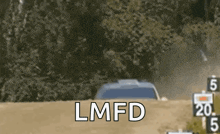 a car is driving down a dirt road with the words `` lmfd '' written on the bottom of the screen .