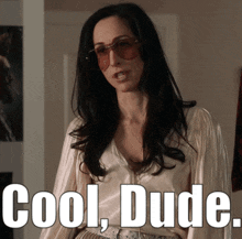 a woman wearing sunglasses and a white shirt with the words cool dude below her
