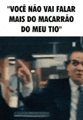a man in a suit and tie is making a funny gesture