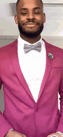 a man in a pink suit and bow tie