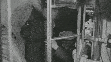 a black and white photo of a man in a room